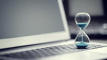 iStock Image - Hourglass + Laptop Hourglass on laptop computer concept for time management and countdown to deadline
