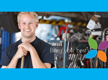 man standing in shop with tools